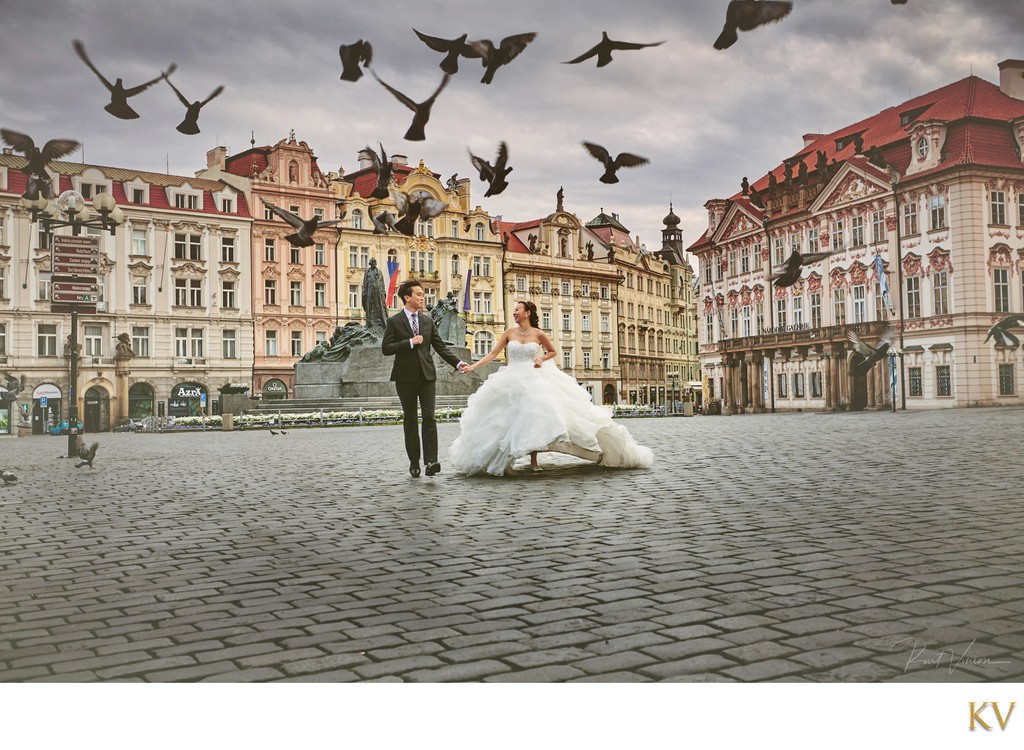 wedding couple running through deserted Old Town Square
