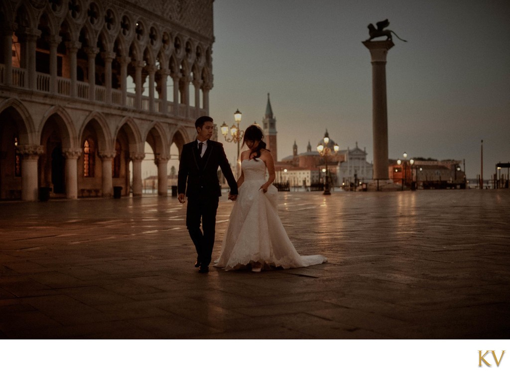 Newlyweds exploring Venice near Doge's Palace at night