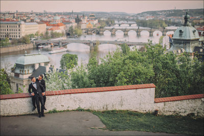 cuddling in their tuxedos overlooking Prague