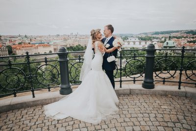 bride & groom embracing above Prague on wedding day