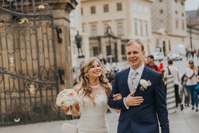 bride & groom walk near Prague Castle gates