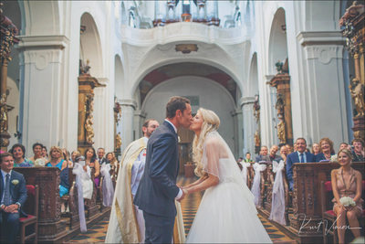 bride & groom kiss Church of St. Thomas Prague wedding