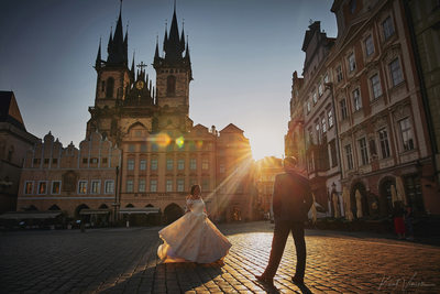 Newlyweds celebrating in Old Town Square at sunrise