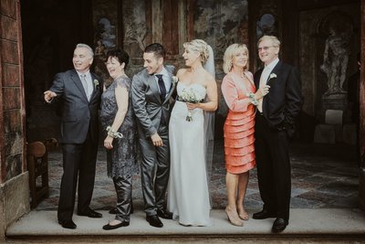 bride & groom and their parents have a laugh