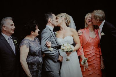 Newlyweds kiss as parents react