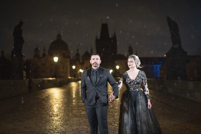Couple Dressed in Black atop Charles Bridge at night