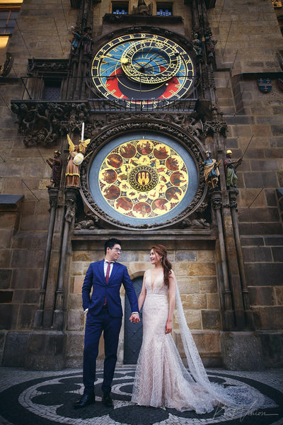 Gorgeous couple standing under the Prague Orloj