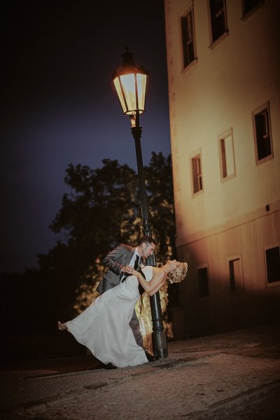 dipping his bride under the gas lamps of Prague Castle