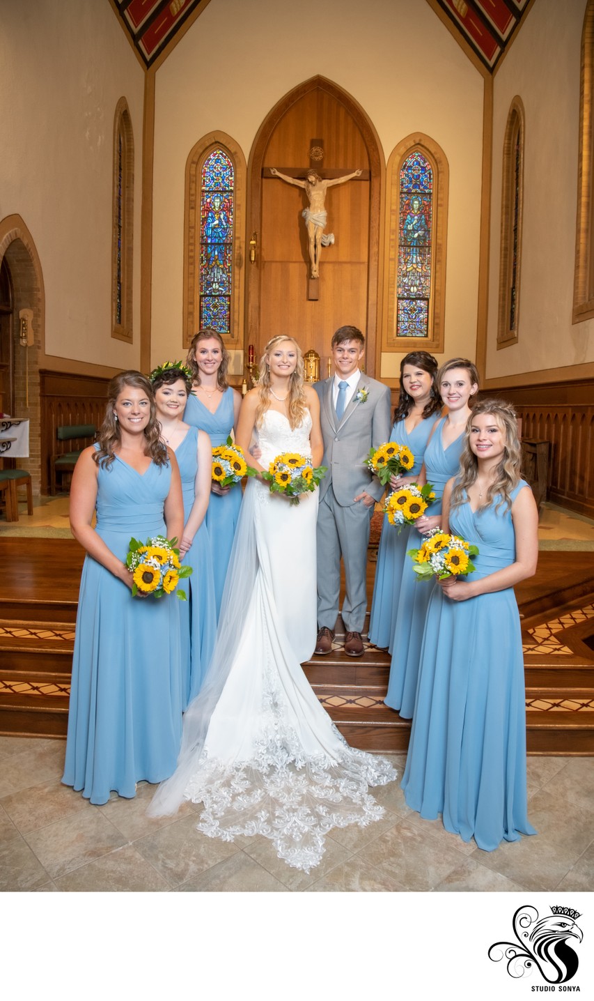 Couple and bridesmaids in front of altar