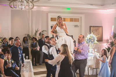 JEWISH WEDDING PHOTOGRAPHY HORA CHAIR DANCE