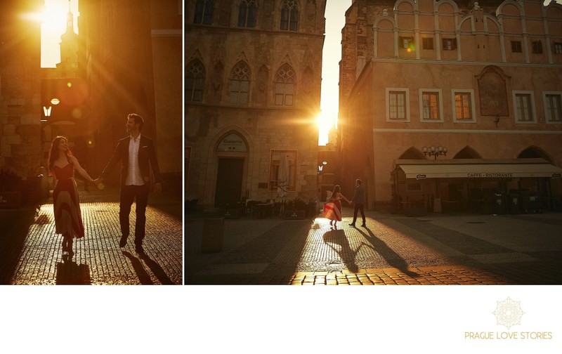  walking in Old Town Square as sun flares behind them