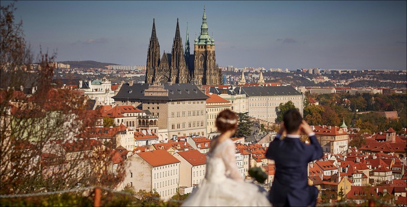 Japanese newlyweds enjoy the view above Prague Castle