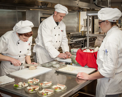 Students prepare restaurant food in cooking class