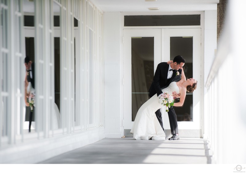 Groom Dips Bride in Hallway at Donalda Club Wedding