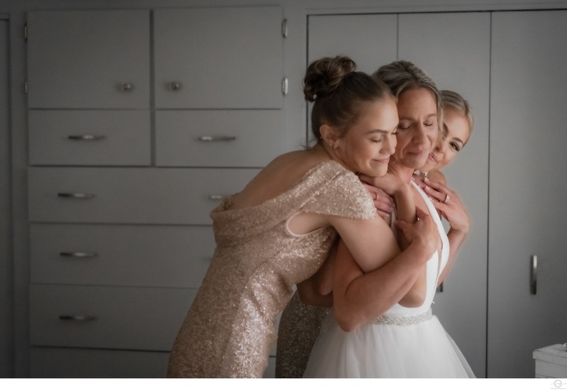 Bride Getting Hug from Daughters on Wedding Day