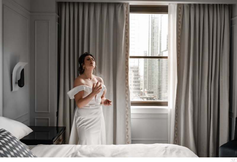 Bride Spraying Perfume in Hotel Room