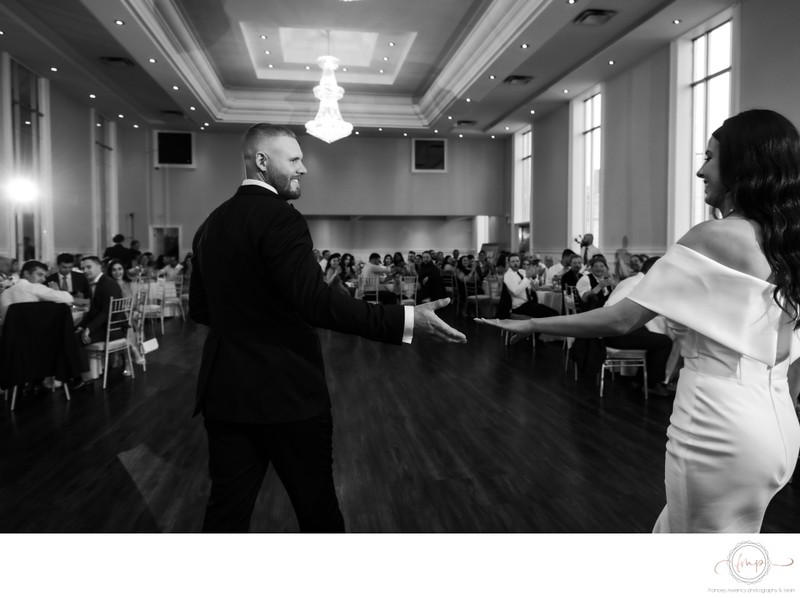 Bride Groom Reach for Each Other at First Dance