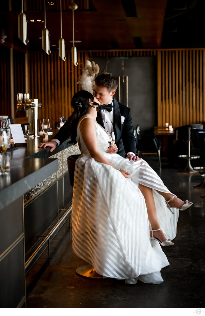 Interracial Bride Groom Kissing at Bar in Canoe