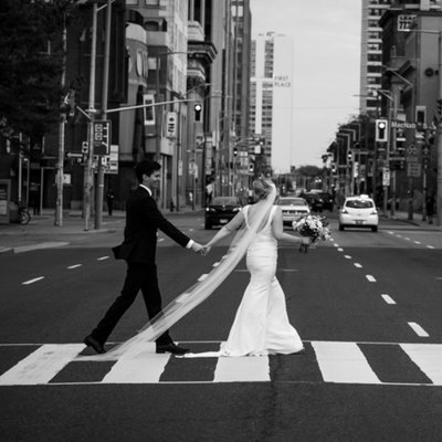 Wedding Couple Walks Across Busy City Street