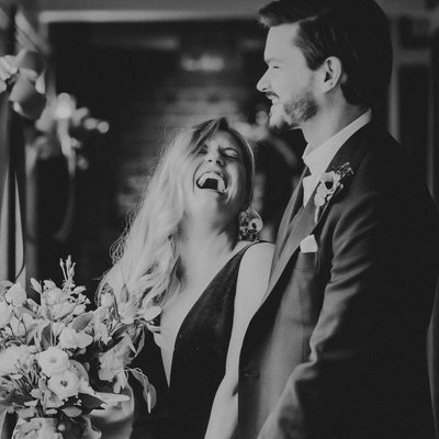 Bride and Groom Laughing Out Loud on Wedding Day