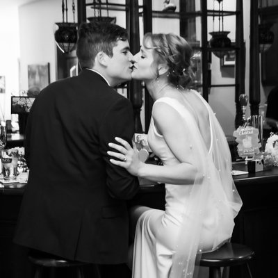 Bride Groom Kissing at the Bar During Their Wedding