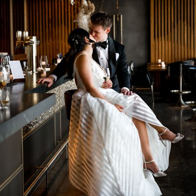 Interracial Bride Groom Kissing at Bar in Canoe