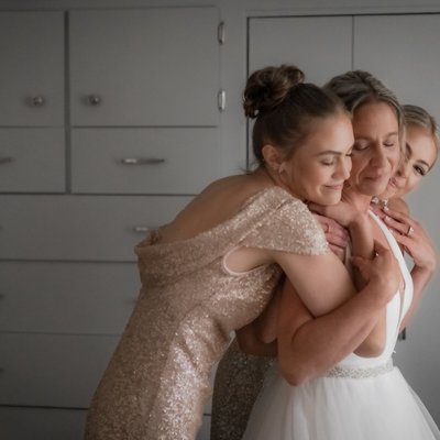 Bride Getting Hug from Daughters on Wedding Day