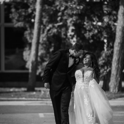 Groom Leans in for a Kiss While Walking at Bear Estate