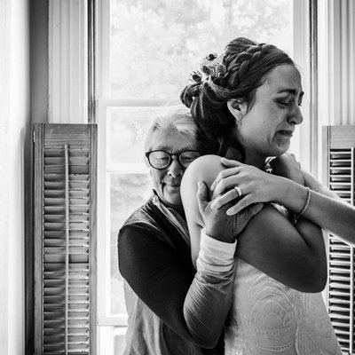 Mother Hugs Bride with Tears in Her Eyes