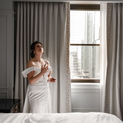 Bride Spraying Perfume in Hotel Room