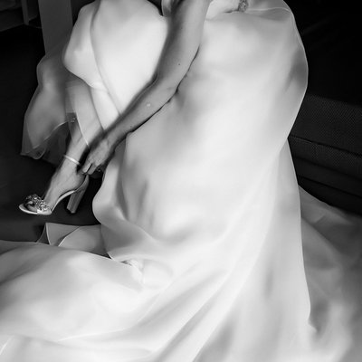 Bride Putting on Shoes on Wedding Day