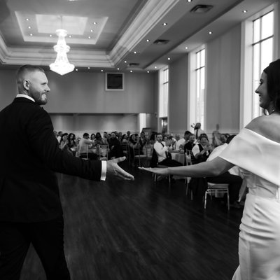 Bride Groom Reach for Each Other at First Dance