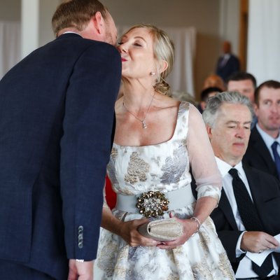 Groom Kissing Mom at Wedding Ceremony