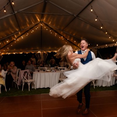 Groom Picks Up Bride During First Dance at Wedding Reception