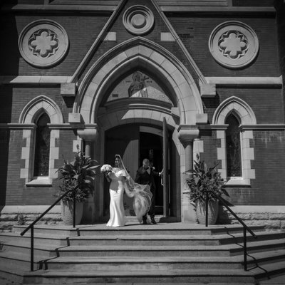 Bride Groom Exiting Catholic Church on Wedding Day