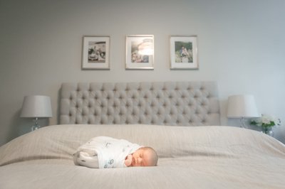 Newborn on all White Bed:  Meaford Family Photographer