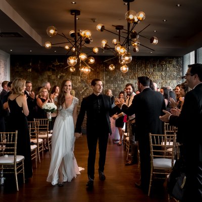 Groom High Fives Guest During Wedding Recessional