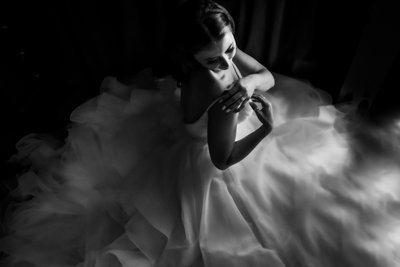 Photojournalistic Portrait of Bride Adjusting Ball Gown