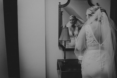 Photojournalism Captures Bride Admiring Veil in Mirror