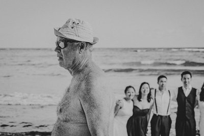 Old Fat Guy Walks in Front of Wedding Party Photo