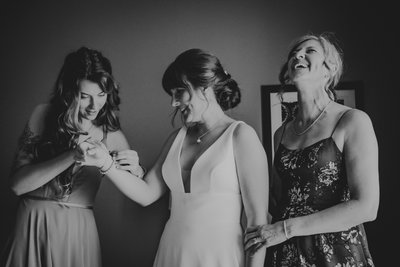 Sister Putting on Brides Bracelet:  Hanover Wedding Photographer