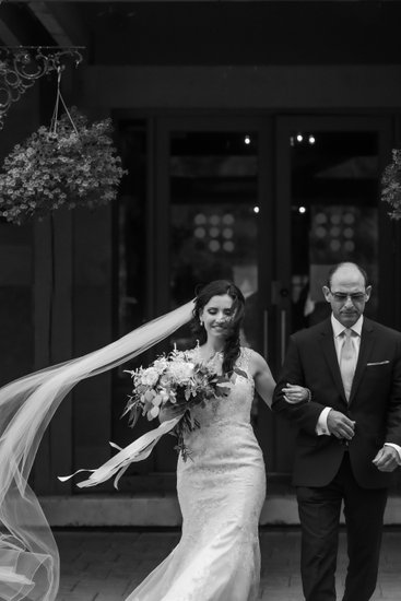 Bride & Father Walk Toward Ceremony with Veil Flying
