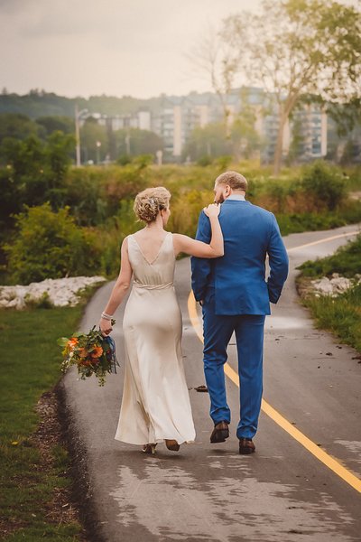 Bride Walking with Hand on Grooms Shoulder in Owen Sound