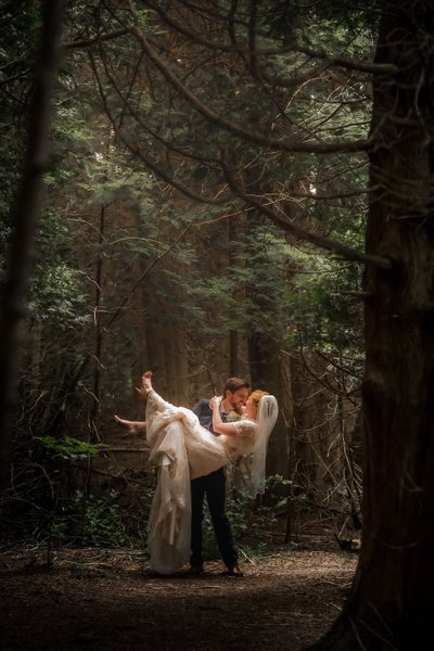 Groom Picks Up Bride in Forest at Millcroft Inn & Spa