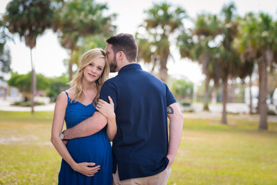 example posing for maternity shoot blue dress