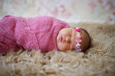 newborn girl with butterfly headset pose jacksonville photos