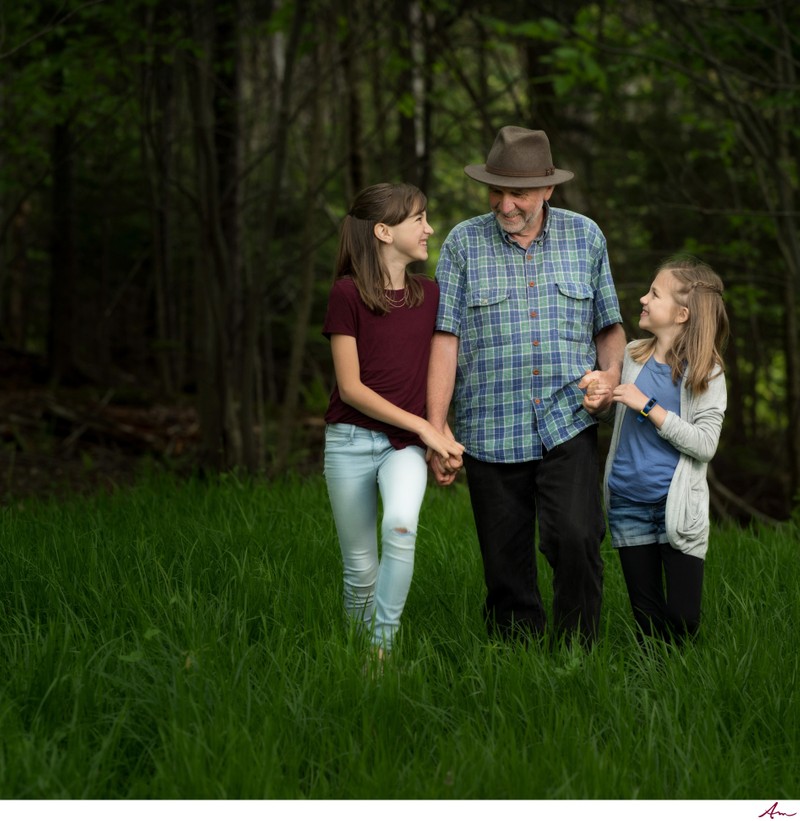Grandfather walking with granddaughters