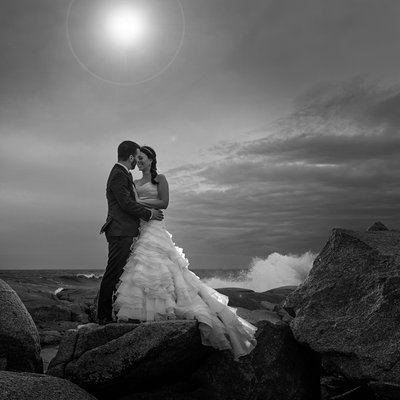 Bride and groom on the rocks at Peggy's Cove. 