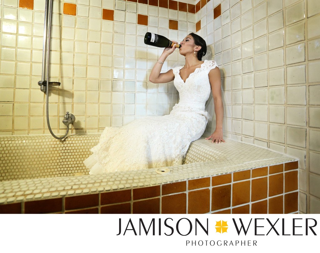 Bride in a bathtub chugging wine from the bottle