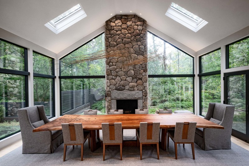 Vaulted ceiling dining room with stone fireplace